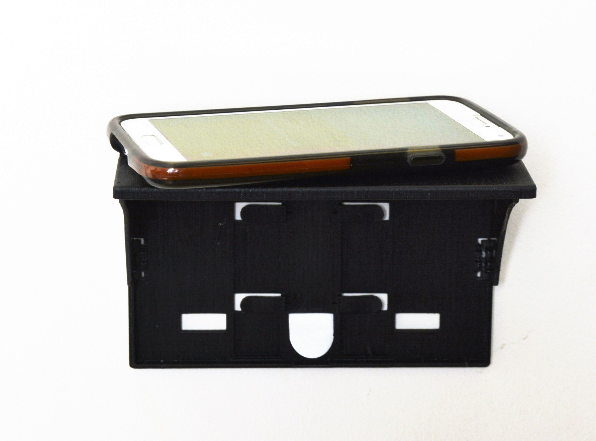 A phone resting on an open Original Edition Pocket Shelf