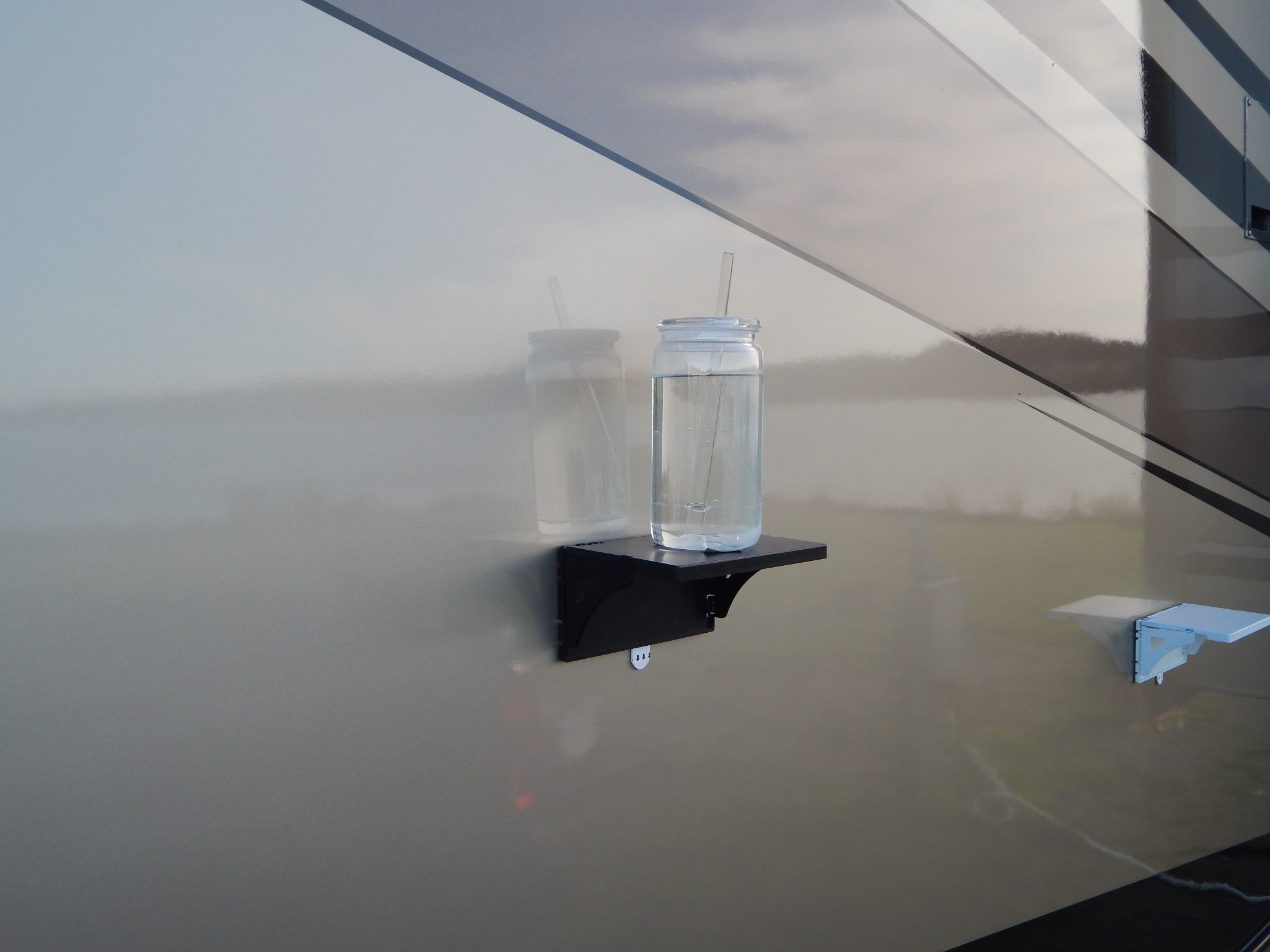 Pocket Shelf holding a drink on an RV wall