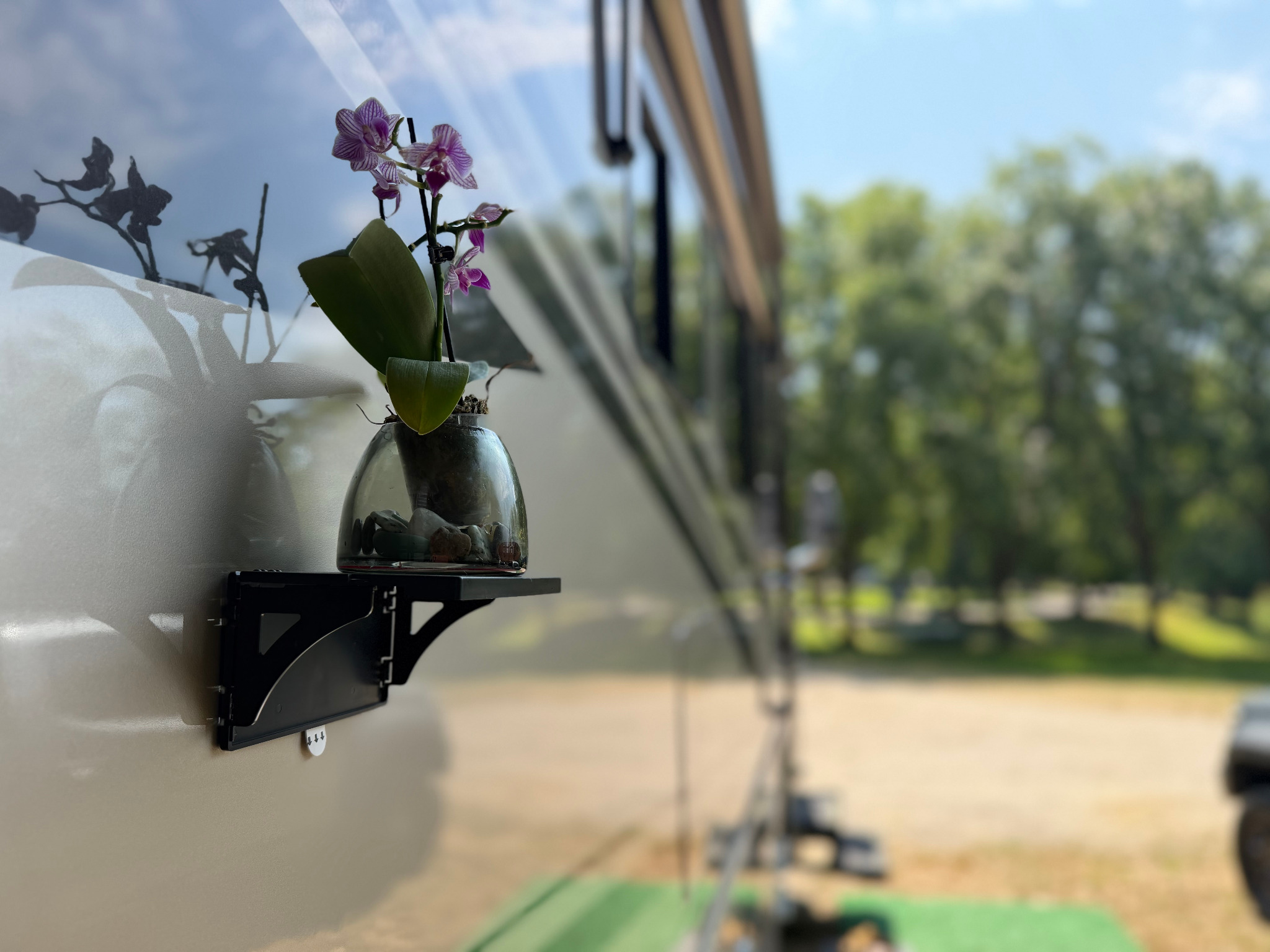 Pocket Shelf holding a flower vase on the outside of an RV