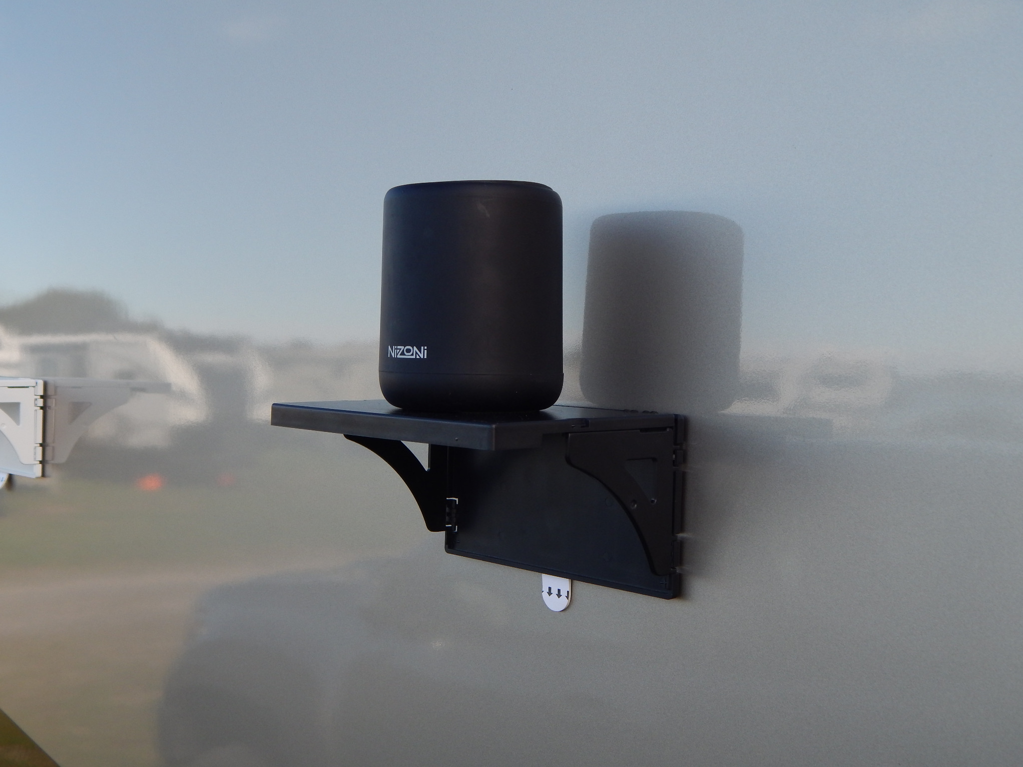 Pocket Shelf holding a portable speaker